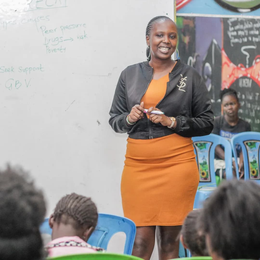 A mentor leading a session with students taking notes